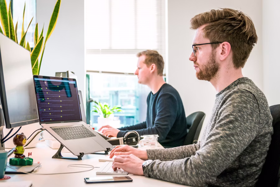 Local business owner consulting with marketer over local search analytics